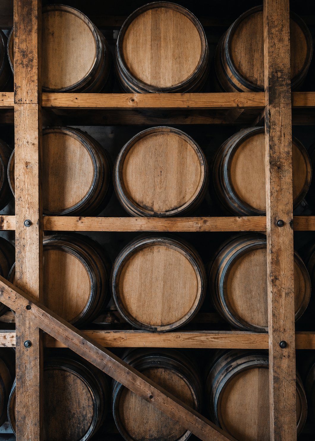 Rows of whiskey barrels inside a distillery